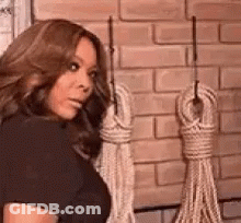 Woman In Black Dress Holding Ropes GIF