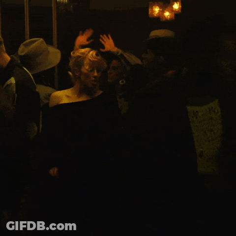 Woman In Black Dress In Dark Room GIF