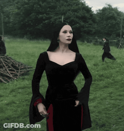 Woman In Black Dress In Field GIF