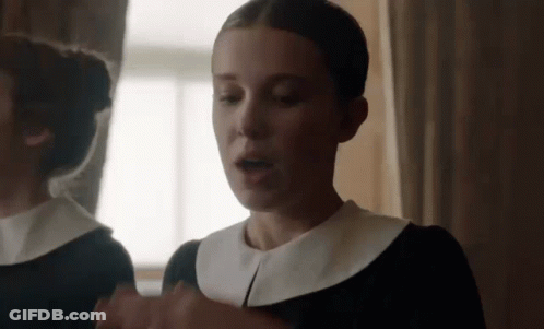 Woman In Black Dress In Front Of Mirror GIF