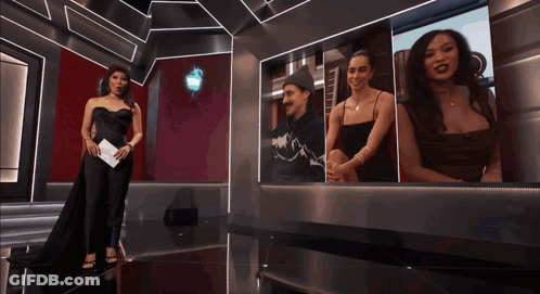 Woman In Black Dress In Front Of Photo Wall GIF