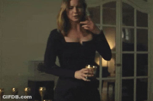 Woman In Black Dress In Front Of Window GIF