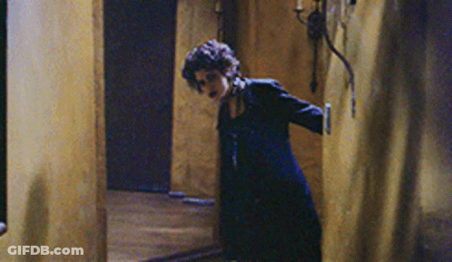 Woman In Black Dress In Hallway GIF