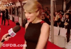 Woman In Black Dress Interviewed On Red Carpet GIF