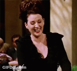 Woman In Black Dress Laughing Holding Martini GIF