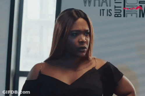 Woman In Black Dress Looking At Camera GIF