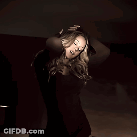 Woman In Black Dress Looking At Camera GIF