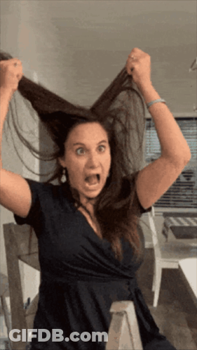 Woman In Black Dress Making Funny Face GIF