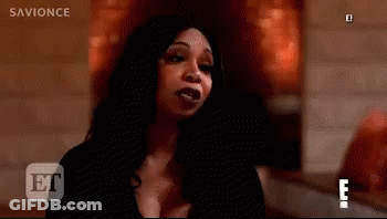 Woman In Black Dress Making Funny Face In Dark Room GIF