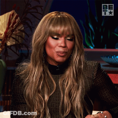 Woman In Black Dress Next To Be Sign GIF