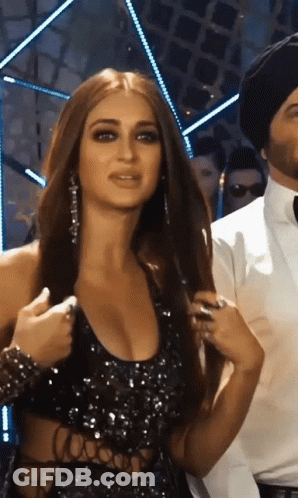 Woman In Black Dress Next To Man In Black Hat GIF