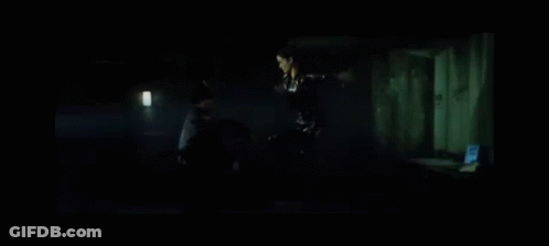 Woman In Black Dress Next To Man In Black Jacket GIF