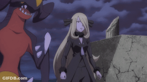 Woman In Black Dress Next To Red And Yellow Monster GIF