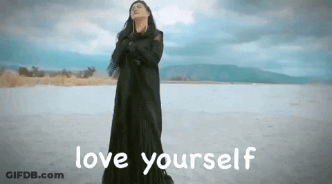 Woman In Black Dress On Beach Saying Love Yourself GIF