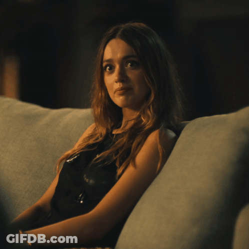 Woman In Black Dress On Couch In Dark Room GIF