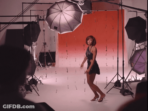 Woman In Black Dress On Red Background GIF