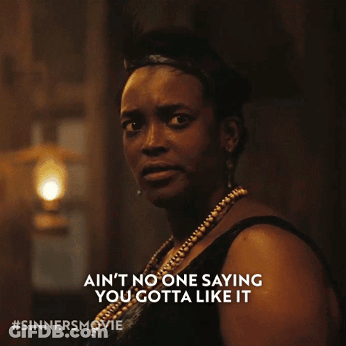 Woman In Black Dress Saying Ain't No One Saying You Gotta Like It GIF