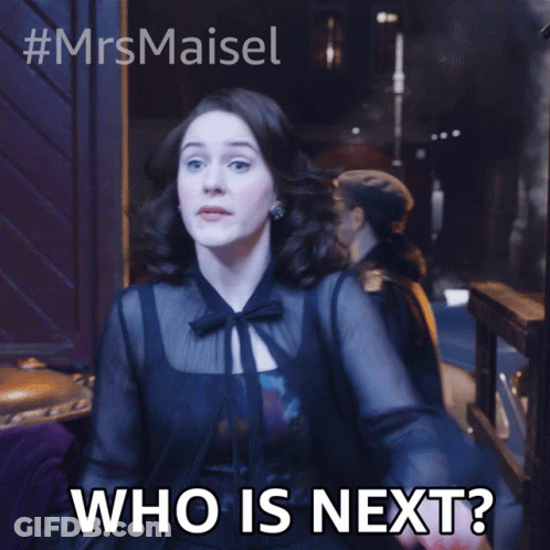 Woman In Black Dress Saying Who Is Next GIF