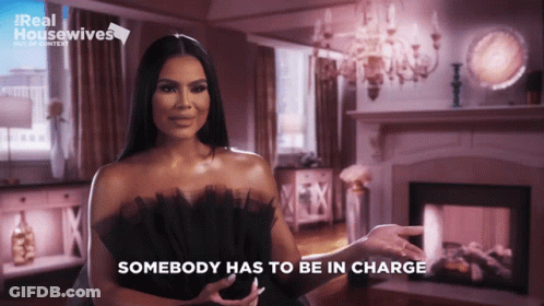 Woman In Black Dress Says Somebody Has To Be In Charge GIF