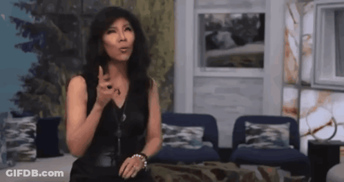 Woman In Black Dress Sitting In Living Room GIF