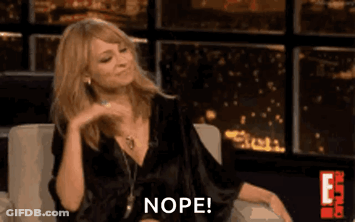 Woman In Black Dress Sitting Making Funny Face Saying Nope GIF