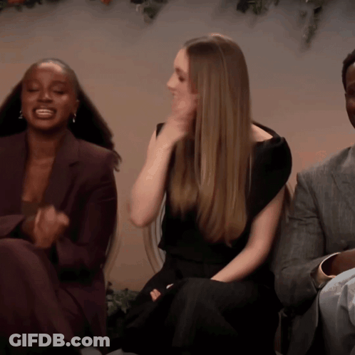 Woman In Black Dress Sitting Next To Two Women GIF