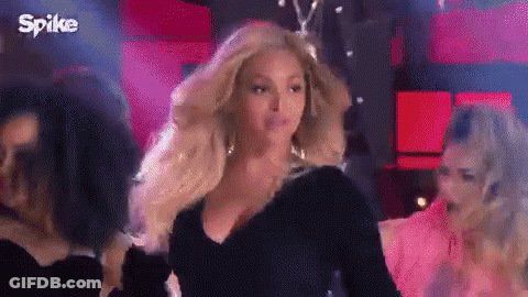 Woman In Black Dress Standing Before Crowd GIF