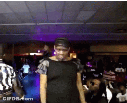 Woman In Black Dress Standing Before Crowd GIF