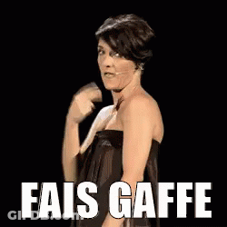 Woman In Black Dress Standing In Front Of Fais Gaffe Sign GIF