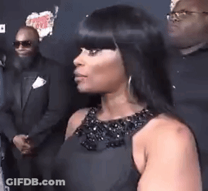 Woman In Black Dress Standing In Front Of Man In Suit And Sunglasses GIF