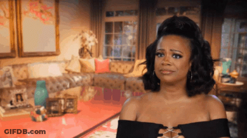 Woman In Black Dress Standing In Living Room GIF