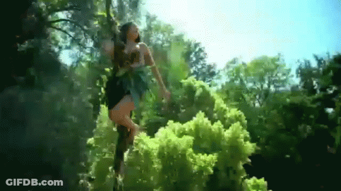 Woman In Black Dress Standing In Woods GIF