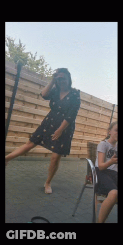 Woman In Black Dress Standing On One Leg GIF