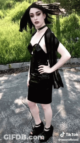 Woman In Black Dress Standing On Road Hands On Hips TikTok Watermark GIF
