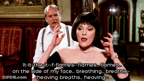 Woman In Black Dress Talking About Flames GIF