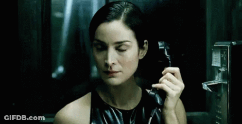 Woman In Black Dress Talking On Pay Phone GIF