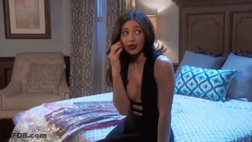Woman In Black Dress Talking On Phone GIF