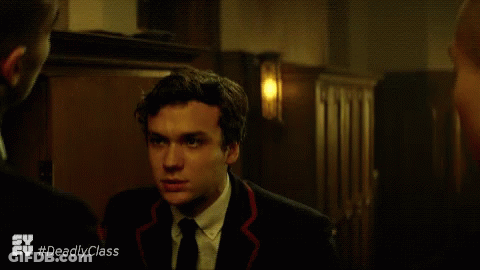 Woman In Black Dress Talking To Man In White Shirt And Suspenders GIF