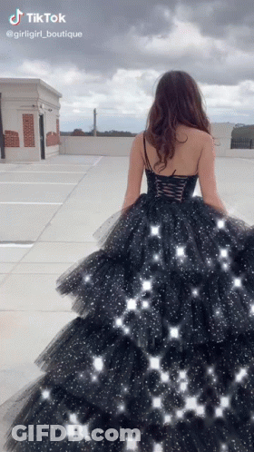 Woman In Black Dress Walking Rooftop GIF