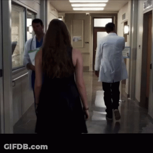 Woman In Black Dress Walking With Doctors GIF