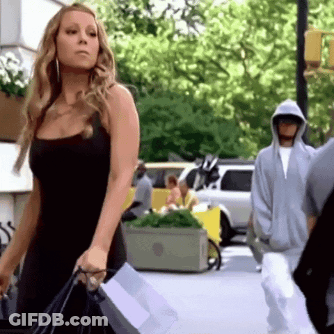 Woman In Black Dress Walking With Shopping Bags GIF