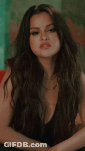 Woman In Black Dress With Plunging Neckline GIF