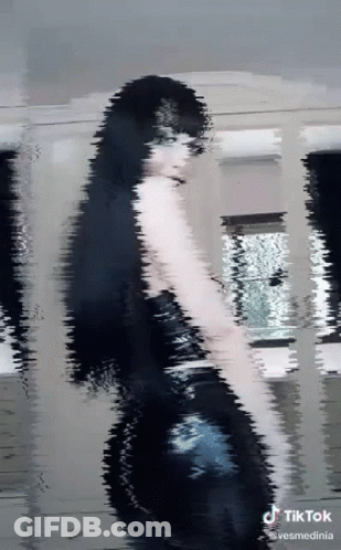 Woman In Black Dress With TikTok Watermark GIF