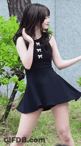Woman In Black Dress With White Bows GIF