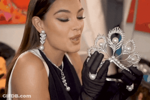 Woman In Black Gloves Holding Tiara GIF