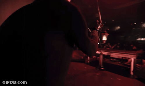Woman In Black Gloves Sings Into Microphone GIF