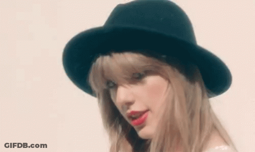 Woman In Black Hat And Red Lipstick Looking At Camera GIF