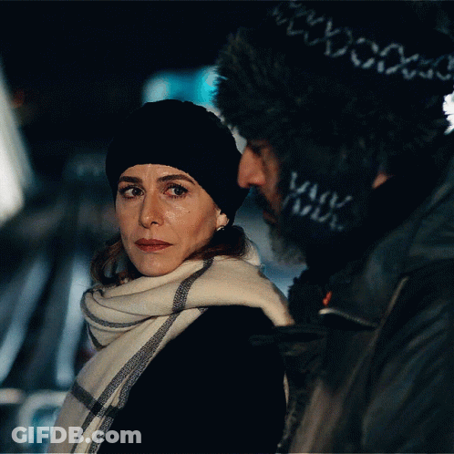 Woman In Black Hat And Scarf Next To Man GIF