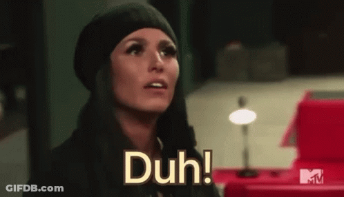 Woman In Black Hat And Scarf Saying Duh GIF
