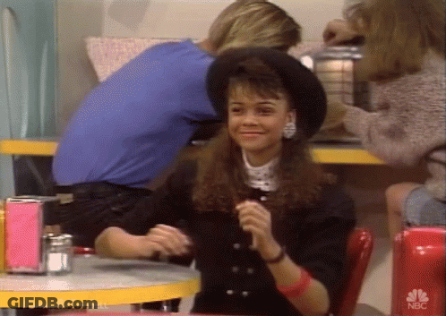 Woman In Black Hat At Table With NBC GIF